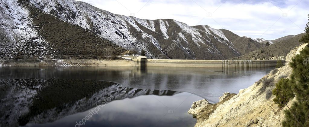 Winter snow reflect from the mountains beyond at a Hydroelectric Dam in Idaho