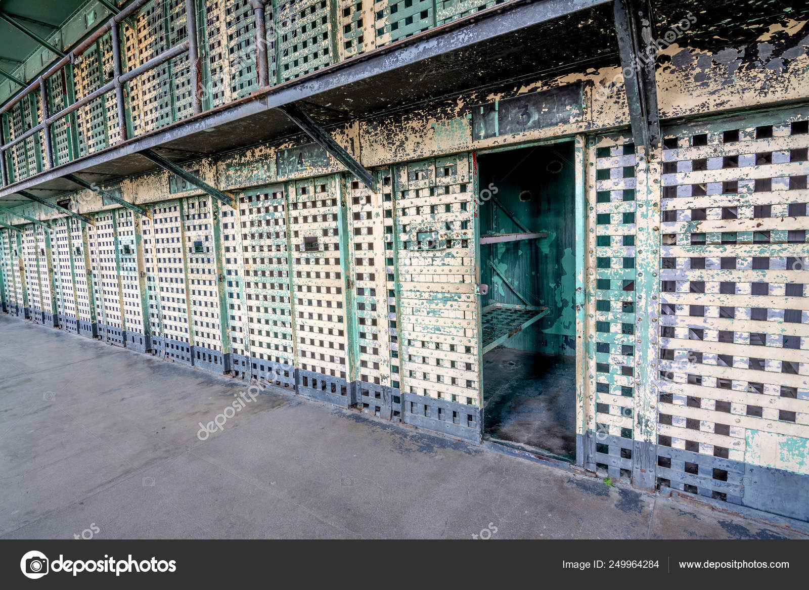 Prison Cell Block Of Barred Doors And One Is Open Stock Photo