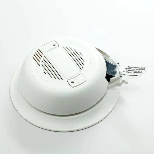 Close up of a classic plastic smoke detector with instructions — Stock Photo, Image