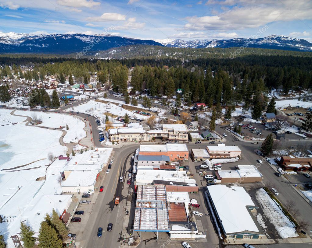 Aerial view of McCall Idaho in winter with mountain range backdr