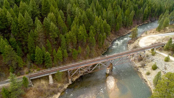 Rusted old metal train bridge with wild Idaho river
