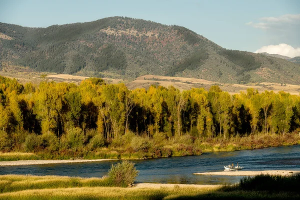 Fishing drift boat floats down the Snake River in Idaho during t