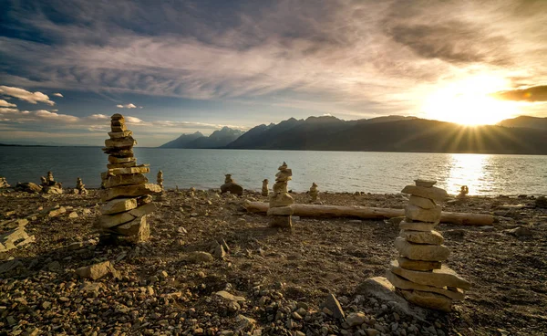 Stacked Rocks on the shore of Jackson Lake in the Tetons at suns