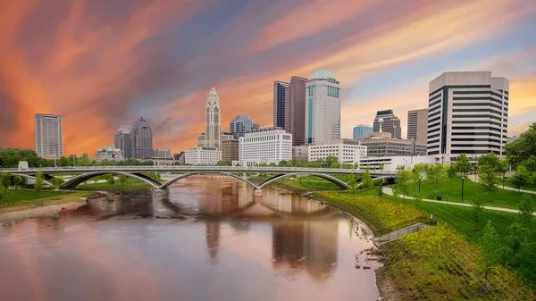Columbus Ohio skyline with the colors of morning over a river re
