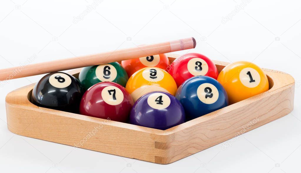 Billard balls racked with a pool cue set for nine ball