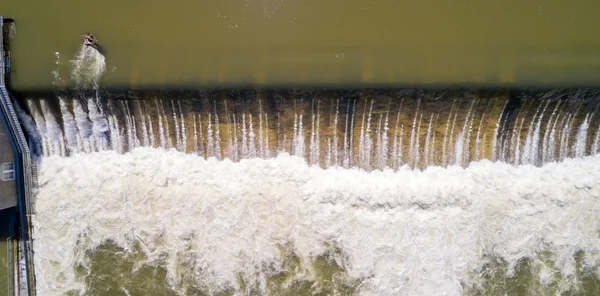 Water Churns as it flows over a diversion dam — 스톡 사진