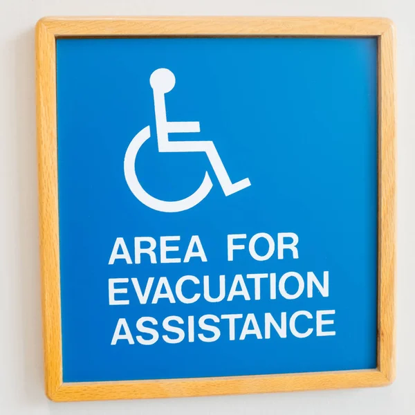 Znak ostrzegawczy ewakuacji z handicapem na ścianie — Zdjęcie stockowe