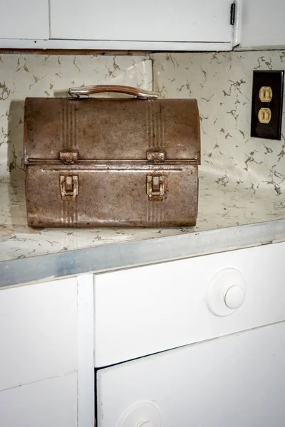 Kitchen counter with a rusted old lunch box