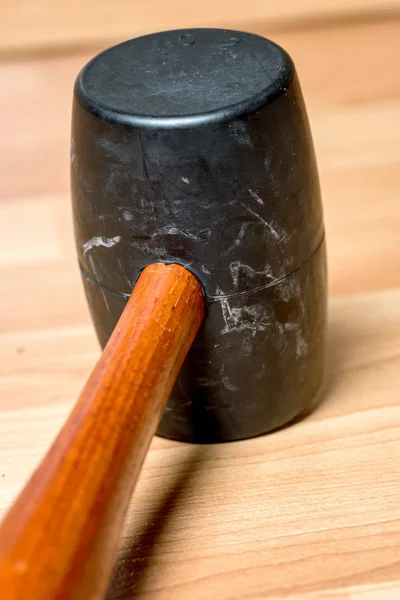 Close up of a rubber mallet with wood handle