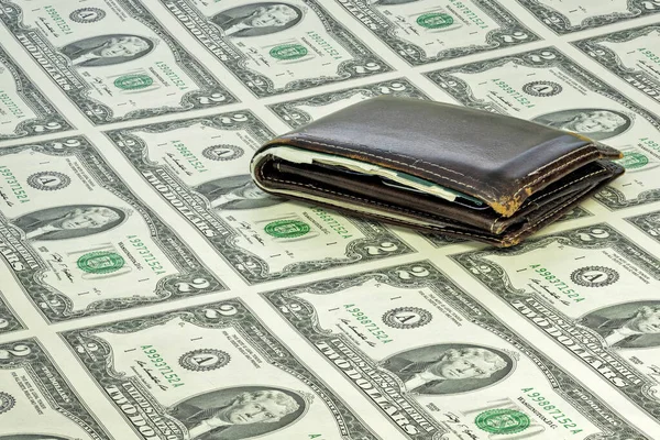 Paper money in a sheet with an old leather wallet — Stock Photo, Image