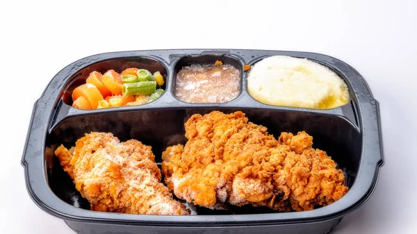 TV dinner in the serving tray still in a frozen state