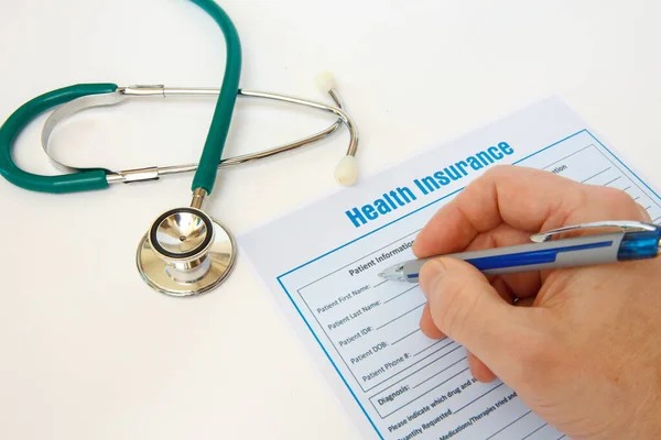 Health insurance with insurance claim form and stethoscope. Health insurance concept