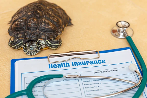 Health insurance with insurance claim form, stethoscope and Red-eared turtle. Health insurance concept