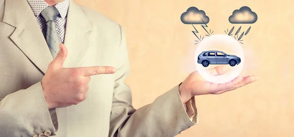 Insurance concept. Car insurance. An insurance agent holds a protective sphere with an image of a care