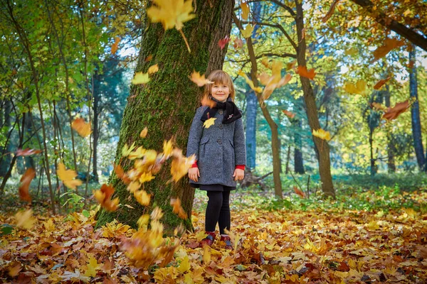 Das Mädchen Lacht Und Spielt Mit Herbstblättern Die Blätter Fallen — Stockfoto