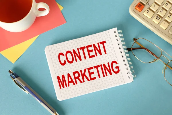 Content marketing is written on a notepad, on an office desk with office accessories.