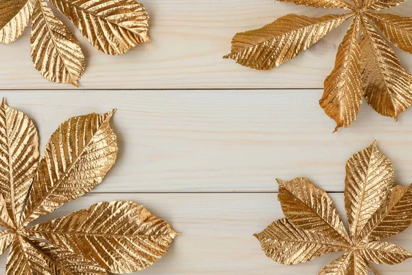 Gold leaf design elements around the edge of the frame. Frame of golden leaves of chestnut.