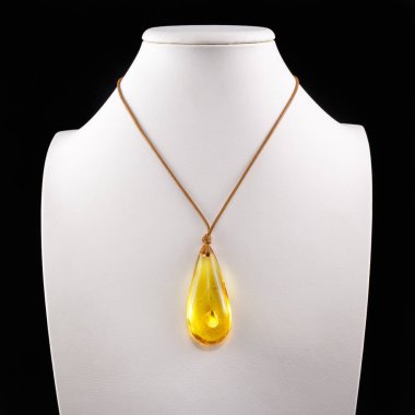 Amber 'ın eşyaları ve mücevherleri. İşlenmiş kehribar. Beyaz arka planda doğal kehribar kolye.