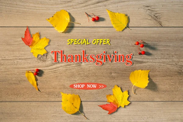 Thanksgiving sale banner with autumn leaves on wooden background