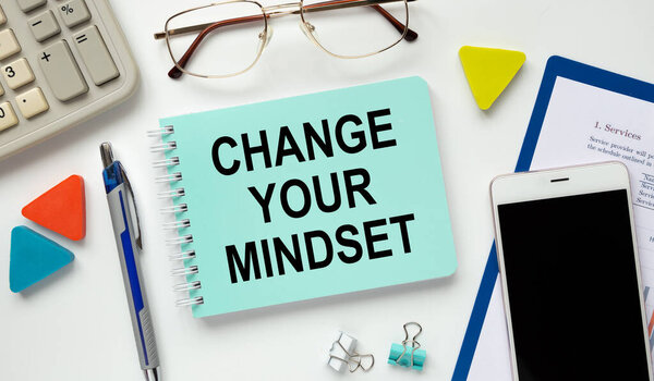 Motivation encouragement quote written on notepad - CHANGE YOUR MINDSET. Clarify your ideas, focus your efforts, and use your time wisely.