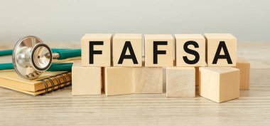 Wooden cubes with the abbreviation Free Application for Federal Student Aid FAFSA clipart
