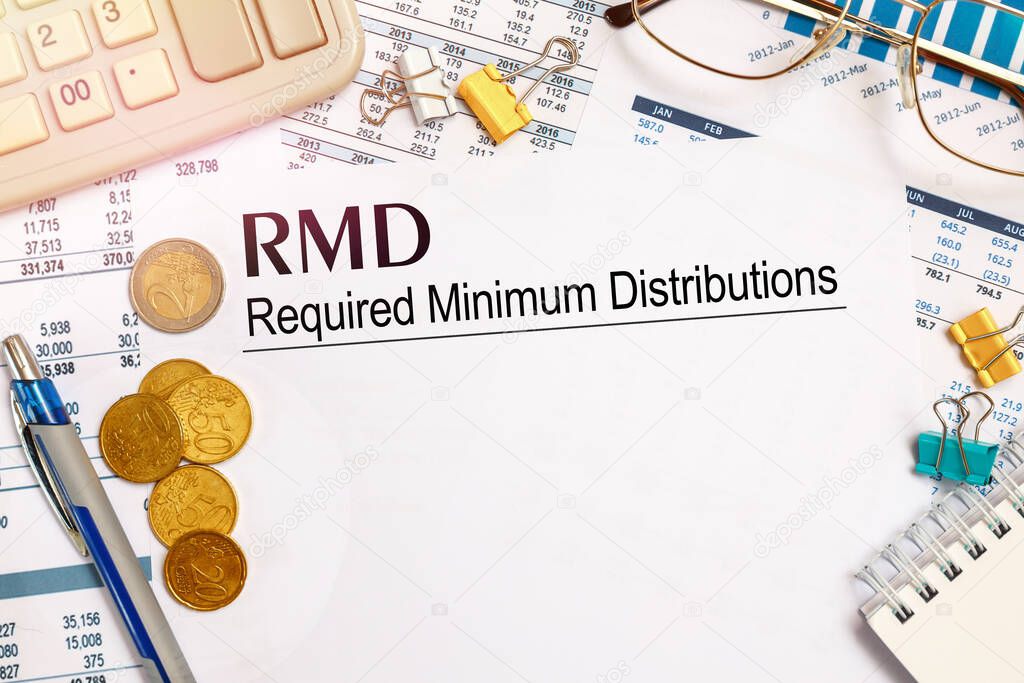 Desktop office desk, notebook, glasses, pen and documents with RMD require minimal distribution on the heading
