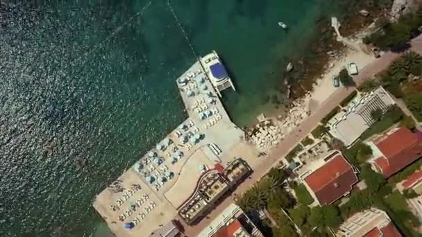 Aerial topshot view of town with buildings, beach and boats in Montenegro — Stock Video