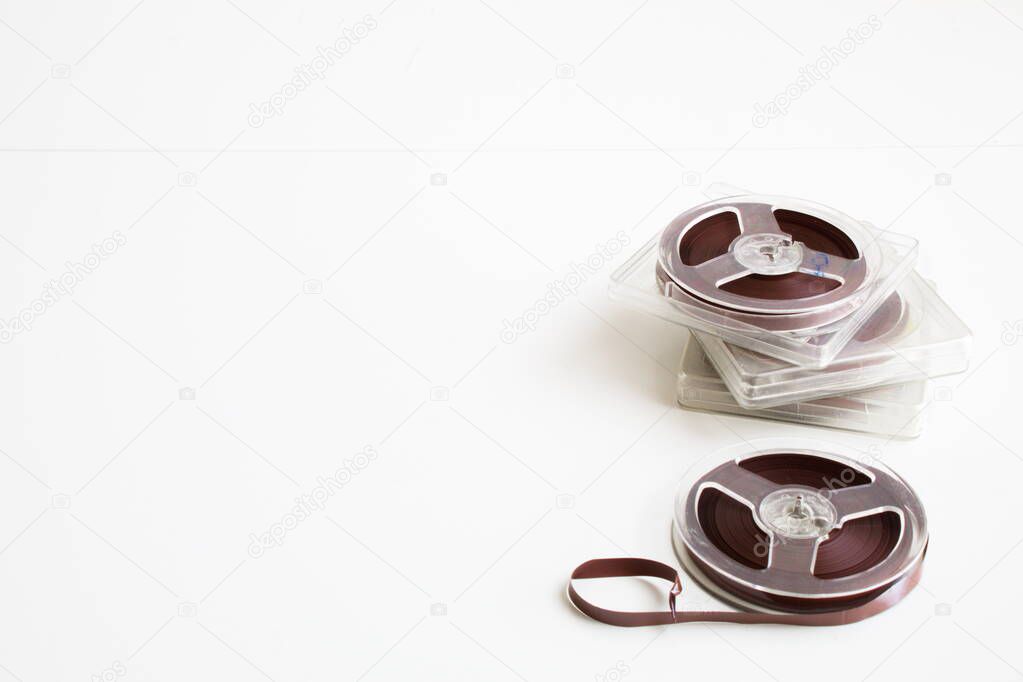 old magnetic tape with recordings on white background