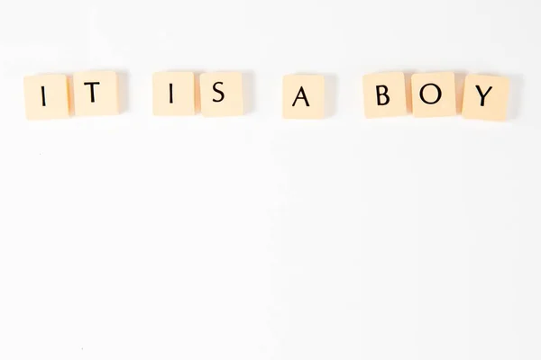 Scrabble inscription IT IS A BOY - on white background. — Stock Photo, Image