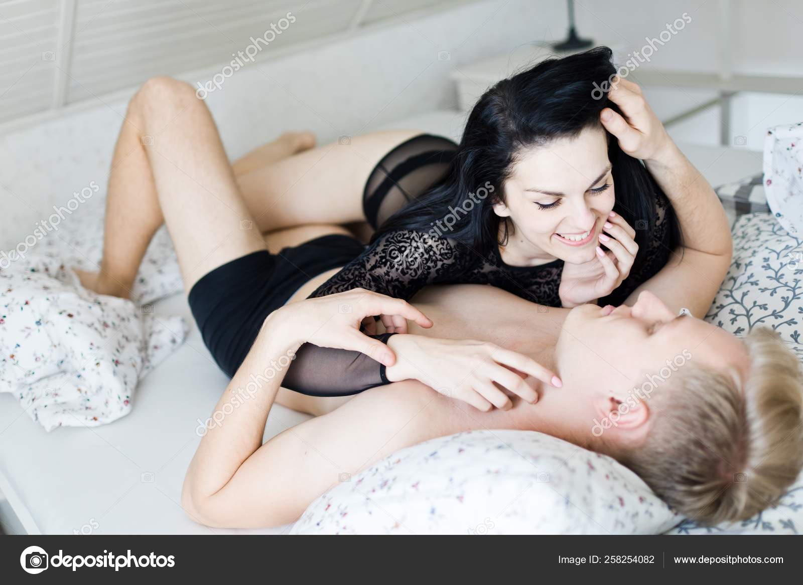 Young loving couple having intimate moments in bedroom