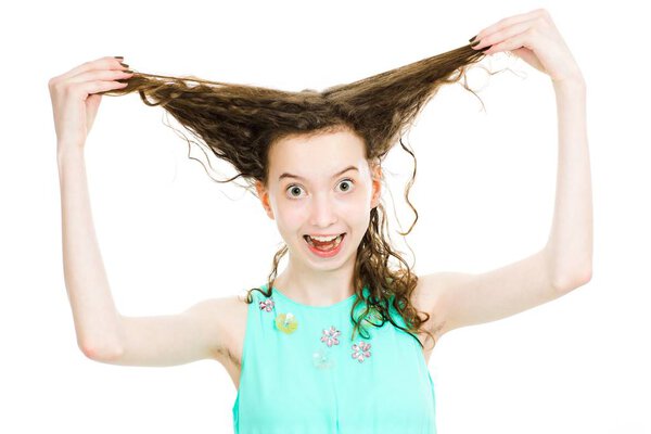 Young teenaged blonde girls wearing turquoise dress making fun w