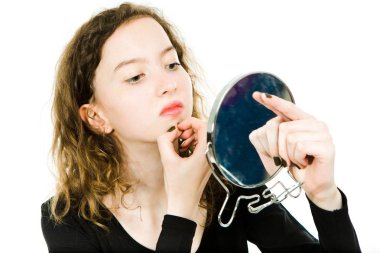 Teenaged girl checking skin in mirror - chin clipart