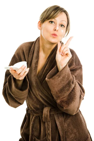 Blonde woman in big oversized brown dressing gown applying face — Stock Photo, Image