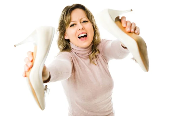 Frustrated woman going to throw away her high heels. — Stock Photo, Image