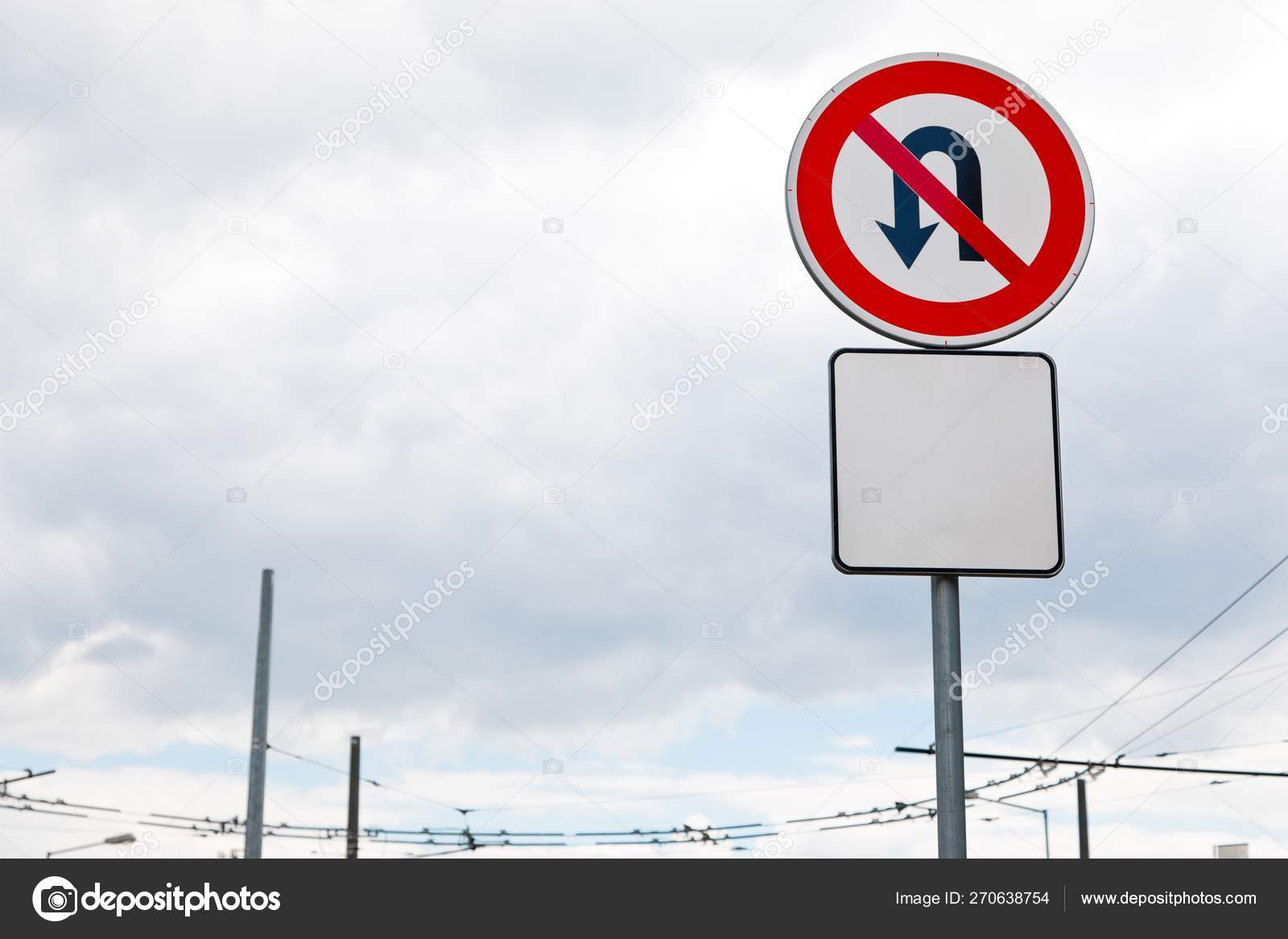 No U turn allowed sign in the city with blank additional plate bellow
