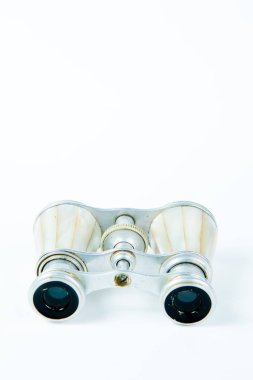 Beyaz arka plan üzerinde perl kulplu kullanılmış dürbün - şıklık aracı