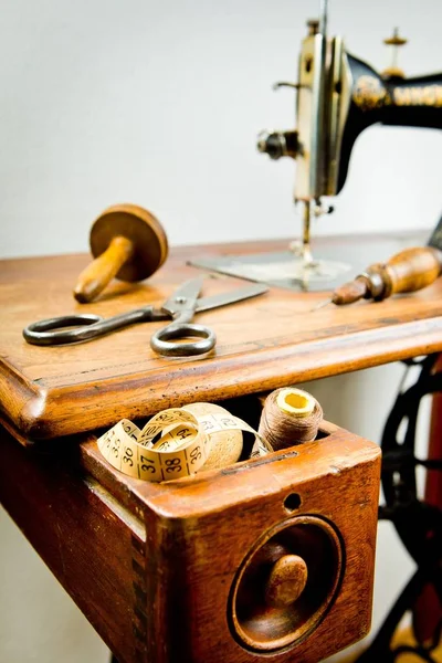 Vintage tailor\'s tools on old sewing machine.