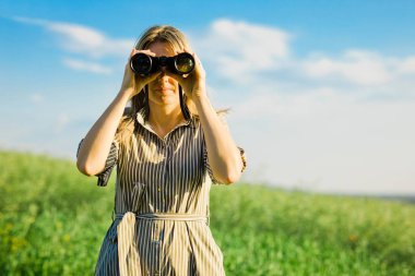 Bir kadın kaşif siyah dürbün kullanıyor - açık.