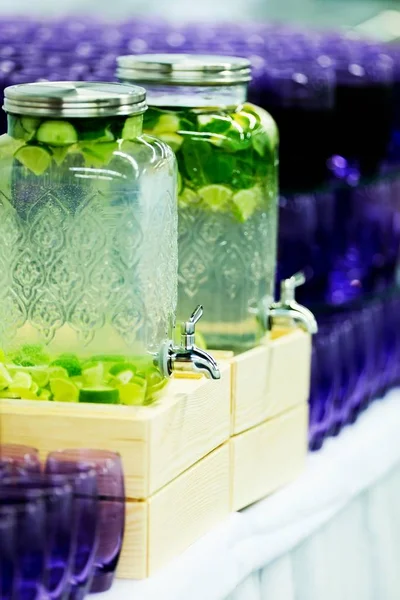 Fruit and vegetable drinks in big glass beverages dispensers — Stock Photo, Image