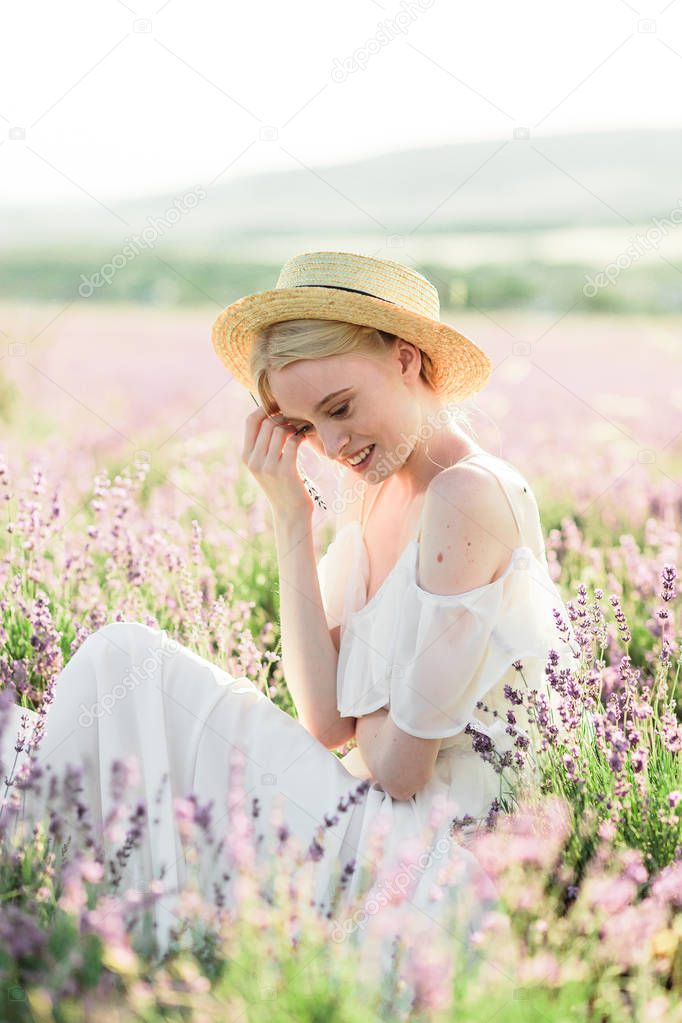 Stuning portrait of girl in light dress in lavender field on sunset