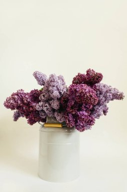 Ahşap masa üzerinde leylak çiçek mor buket ile şık bir vazo