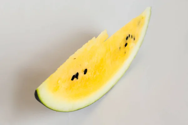 Cut a slice of ripe yellow melon on a white background — Stock Photo, Image