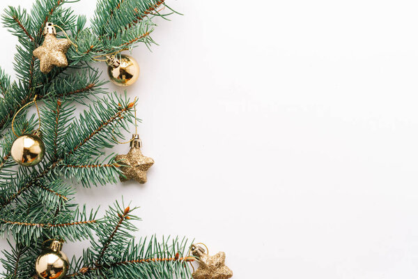 Christmas or new year's background, plain composition of Christmas golden toys and fir branches, Flatlay, empty space for greeting text.christmas concept.