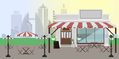 Sokak, halka açık kafe, caddelerde masalar ve metropolün manzarası.