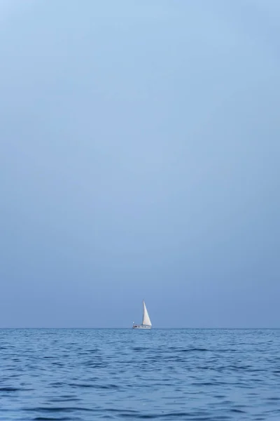 boat and motorboat in the calm sea, sea at rest in a sunset