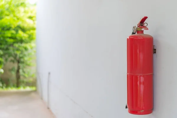 Fire Extinguisher on white wall at home or office.