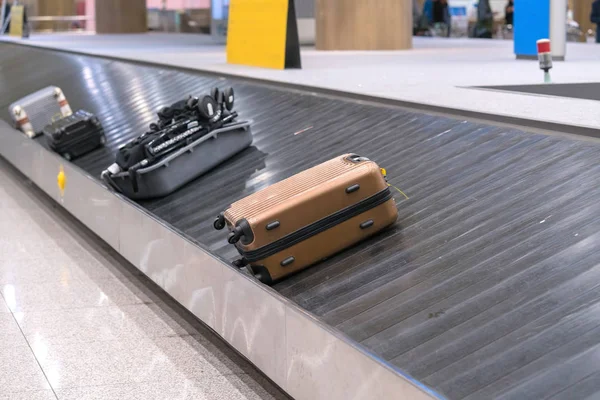 Suitcase or luggage with conveyor belt in the airport.