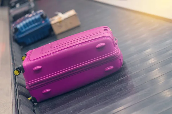 Suitcase or luggage with conveyor belt in the airport.