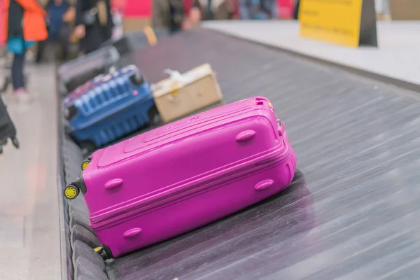 Suitcase or luggage with conveyor belt in the airport.