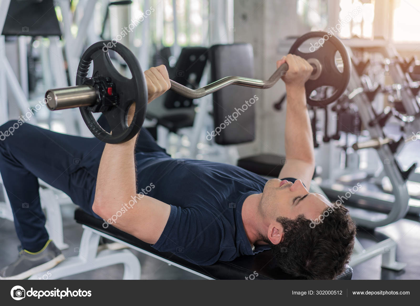 Handsome Weightlifter Lifting Barbells Bench Press Working Out W